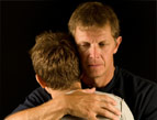 father and son embrace